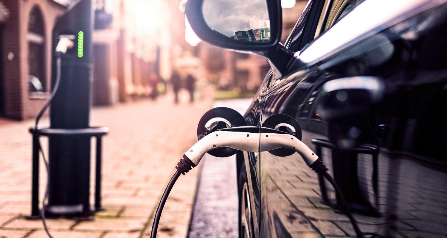 Black car connected to charge